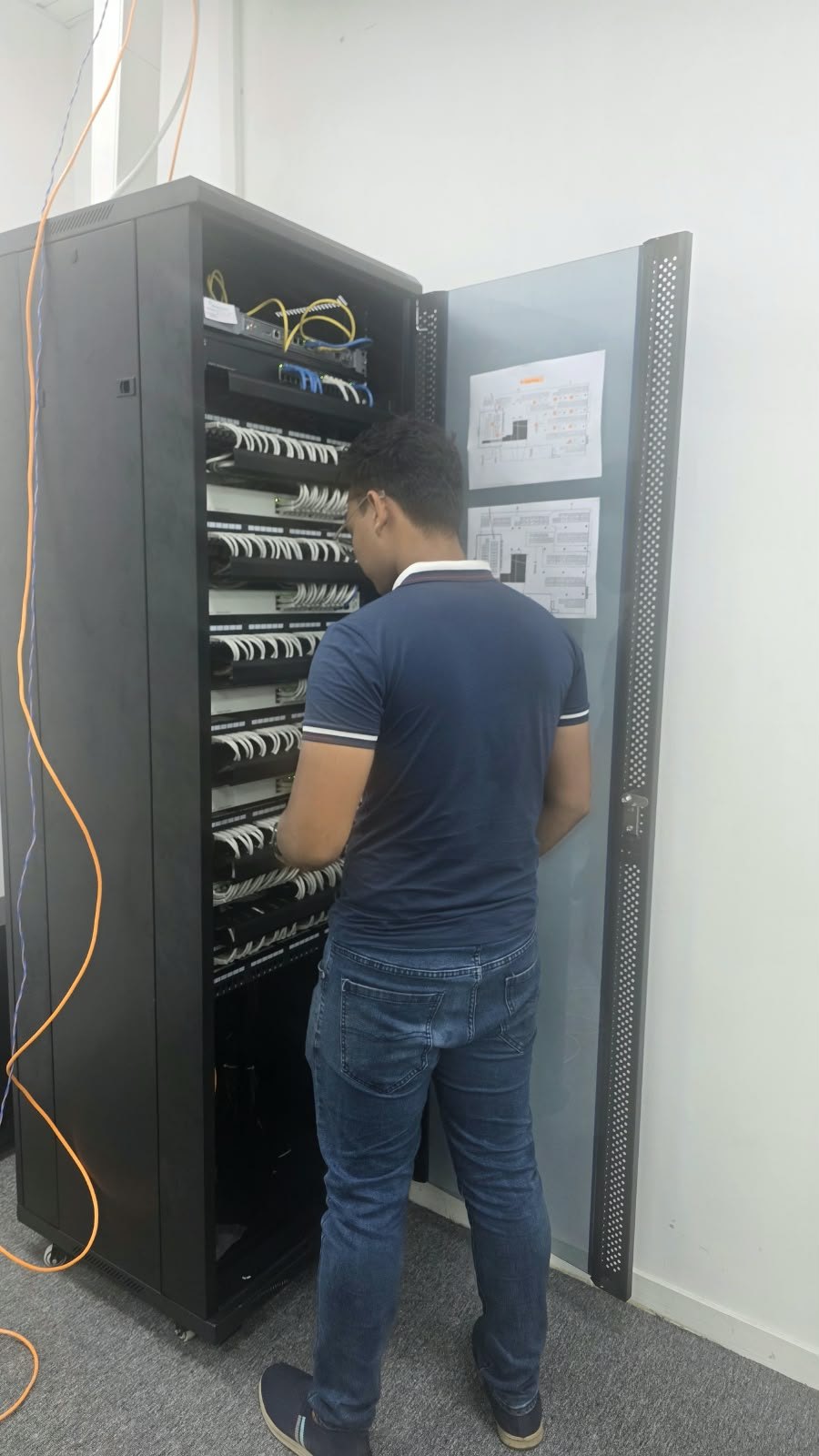 Solution House engineer performing network rack cabling